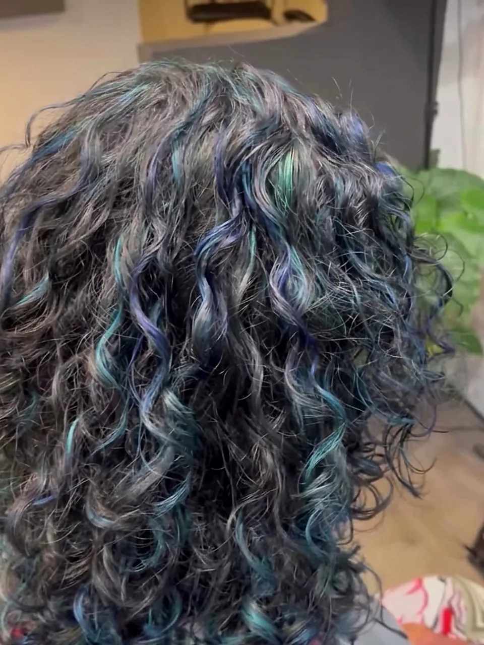 After: springy defined curls threaded with blue and teal.