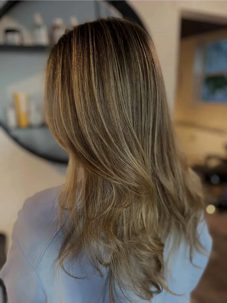 After: soft dimensional blonde with bright ribbons through the mid-lengths.