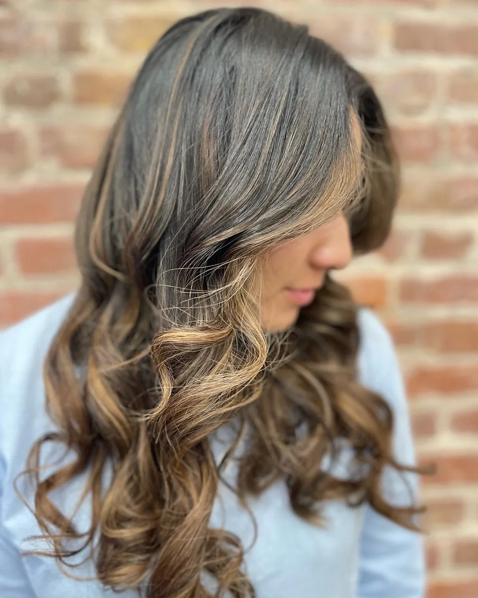 Cool-toned blonde balayage on long layered hair.
