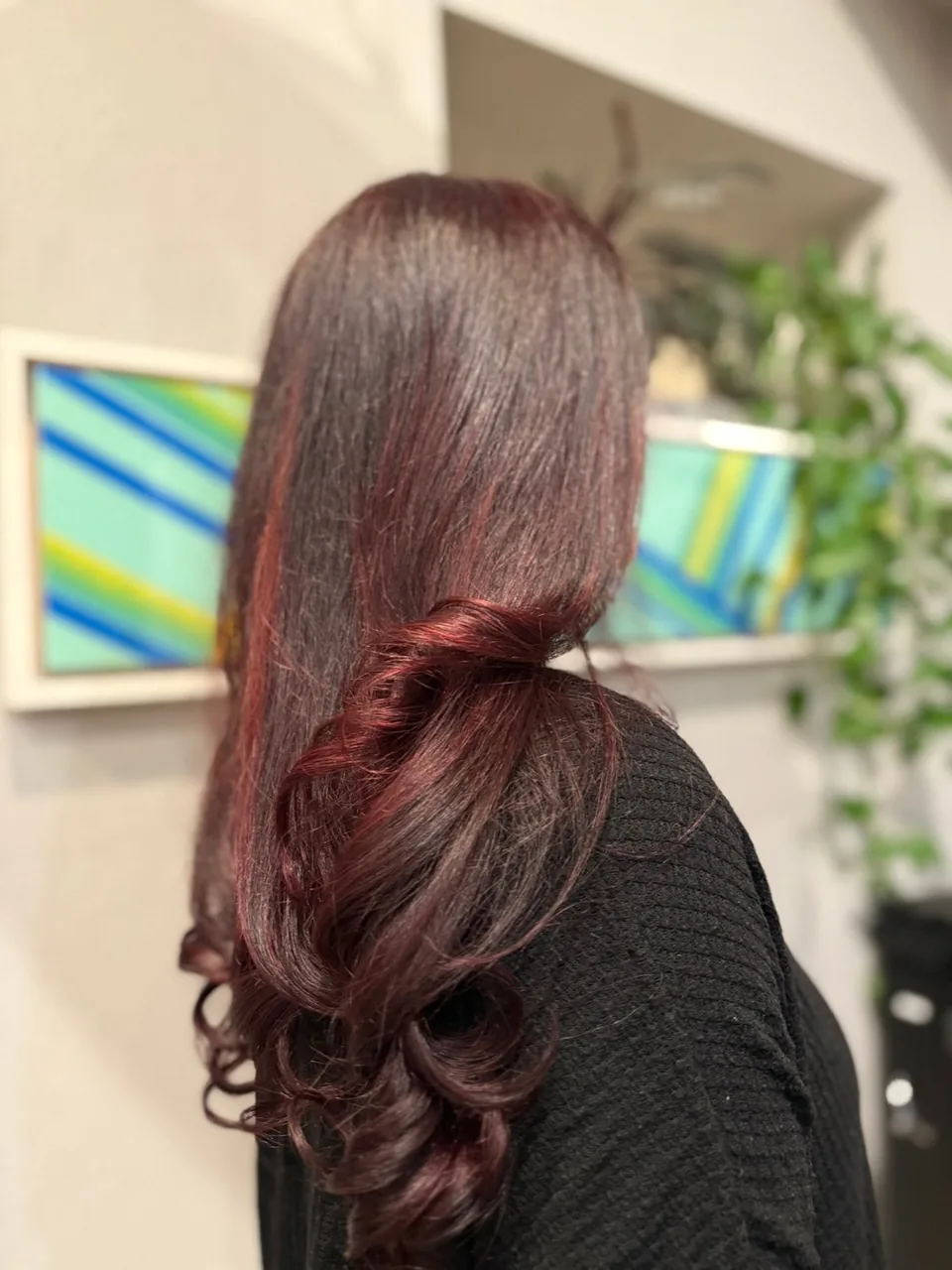 Deep burgundy color with soft curls at the ends.