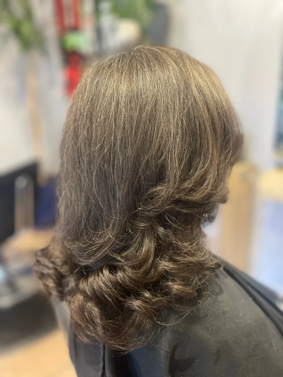 Fine ribbon highlights running through long hair.