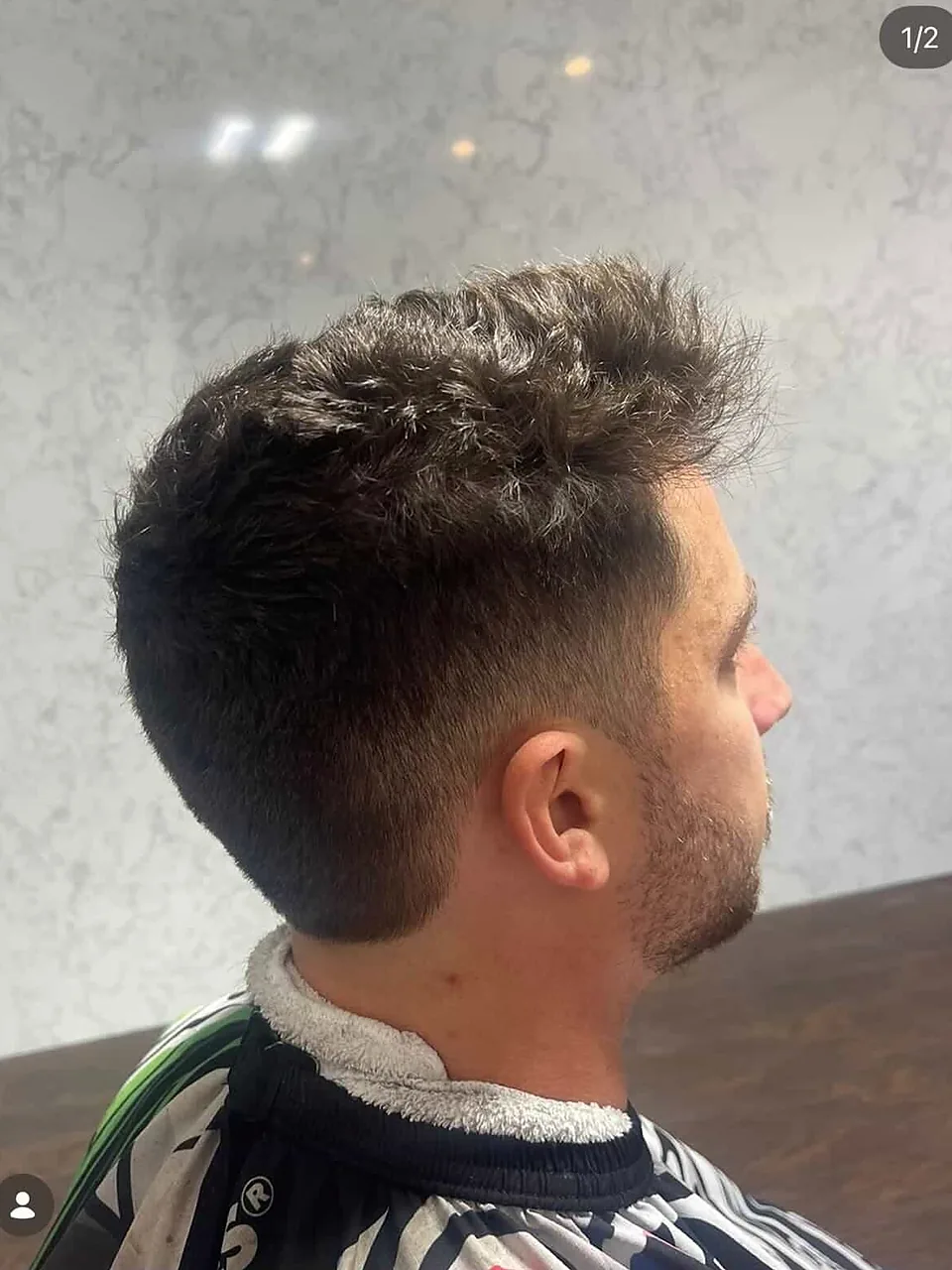 A men&rsquo;s textured cut, spiky through the top with tight tapered sides.